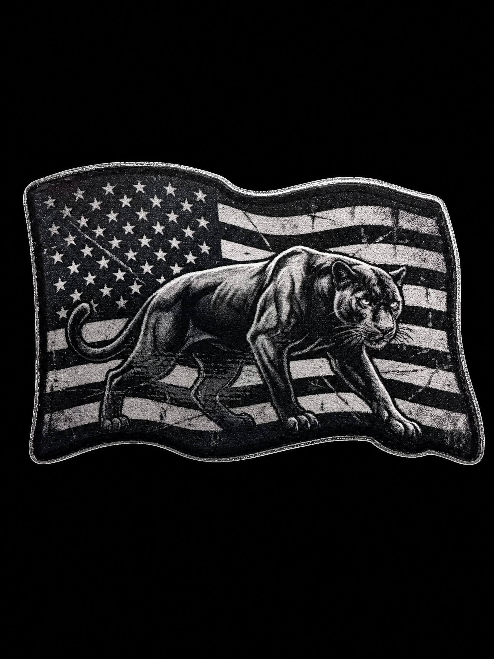Black panther walking across a distressed grayscale American flag UV decal